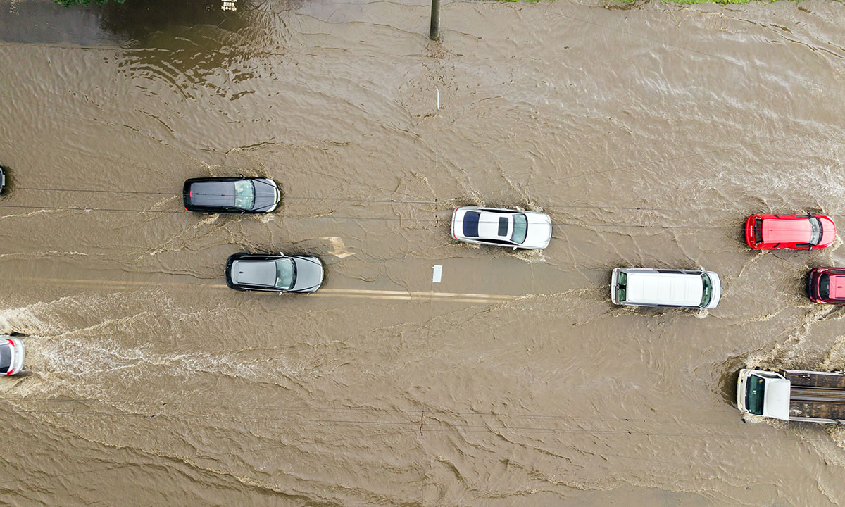 aerial-view-traffic-cars-driving-flooded-road-with-rain-water